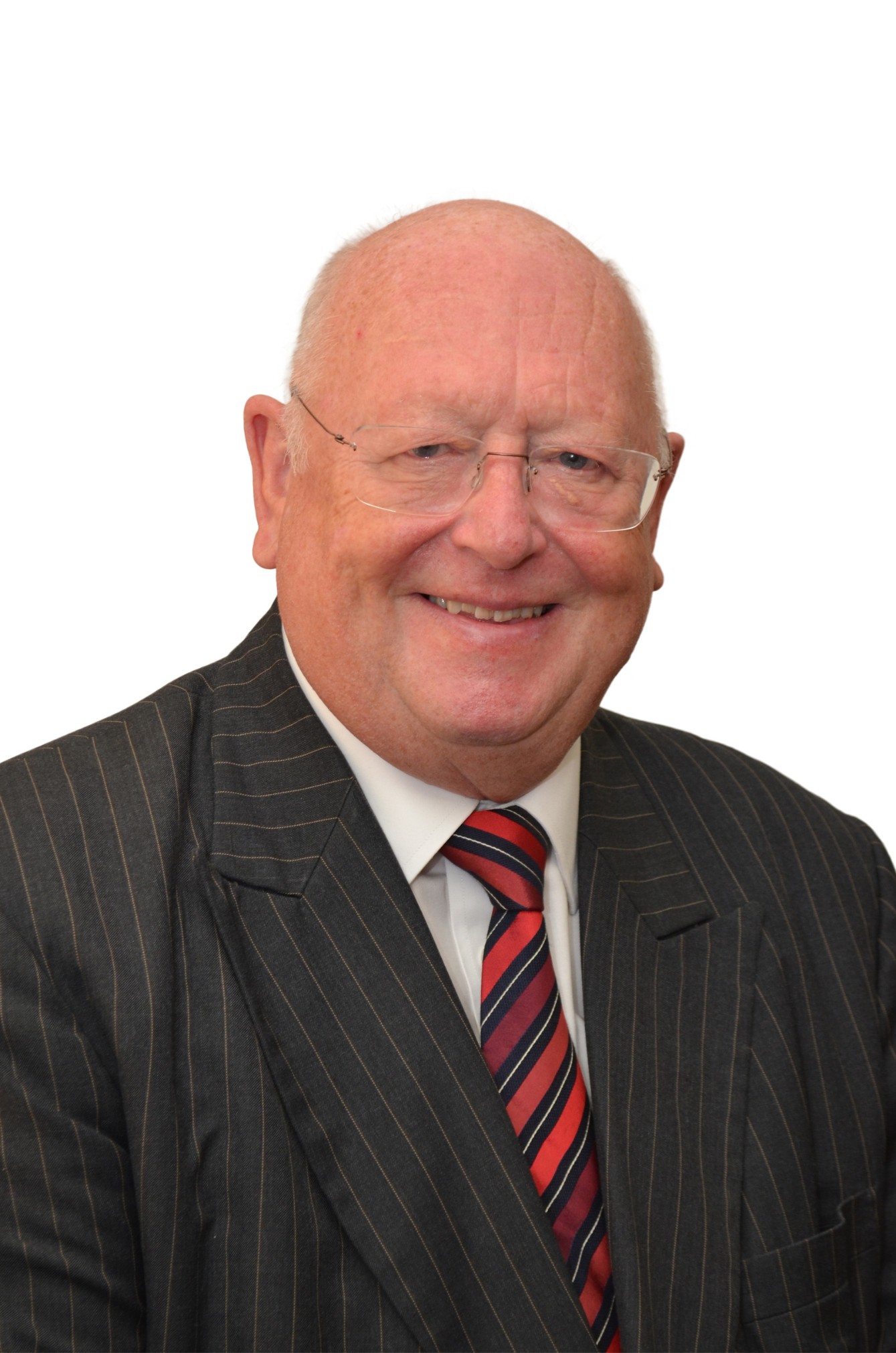 Professor Wallwork wearing a suit and tie, smiling.