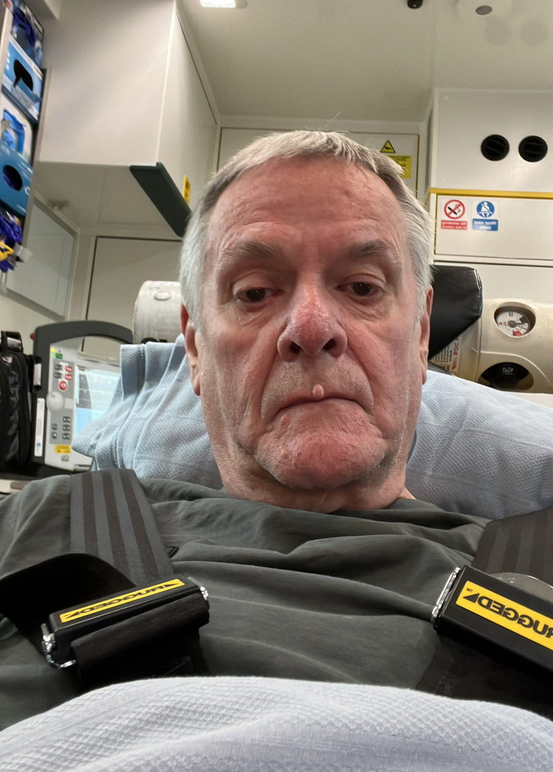 Geoff laying down in the back of an ambulance.