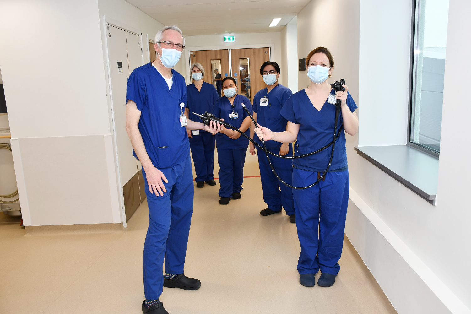 People standing in blue scrubs. 