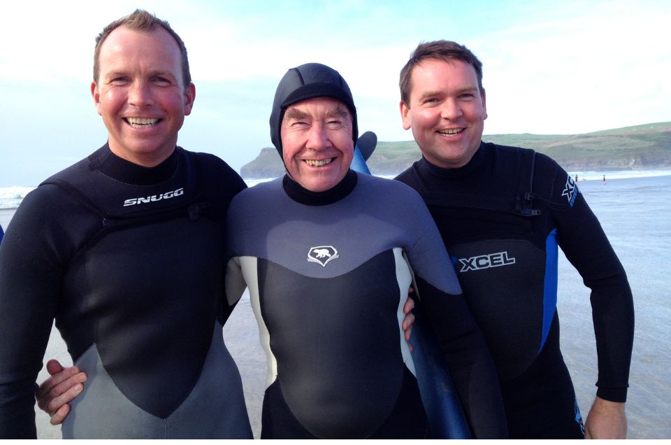Sir Terence with William and Arthur in black body suits holding surf boards.jpg