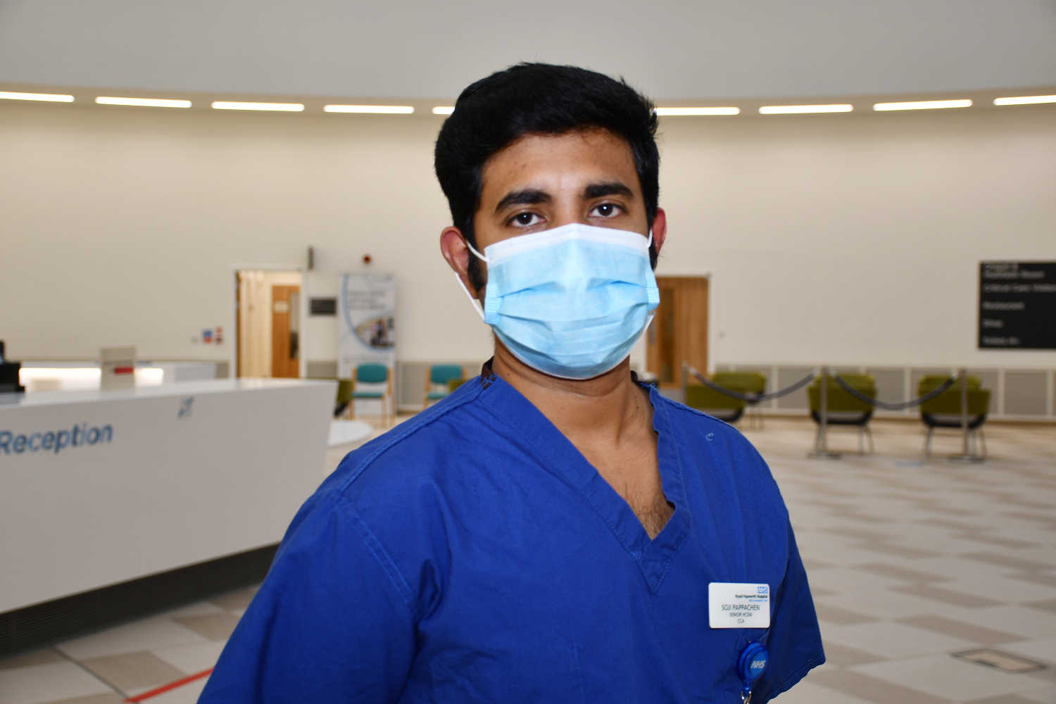 Man in scrubs wearing a mask