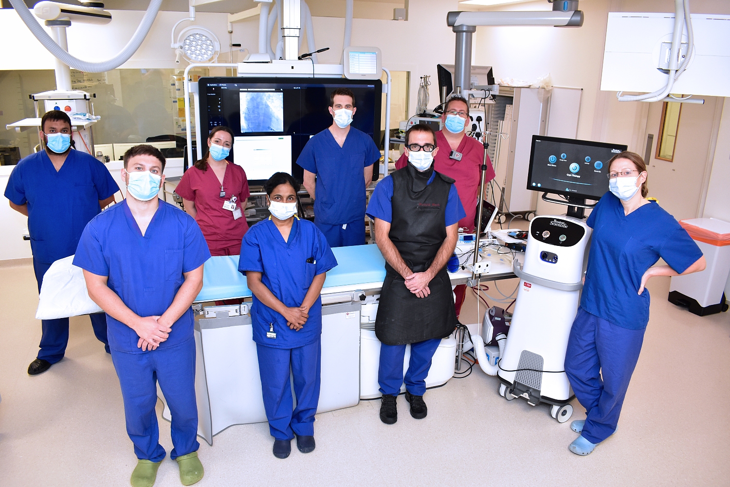 The multidisciplinary team who were involved in the procedure, standing apart wearing masks.jpg