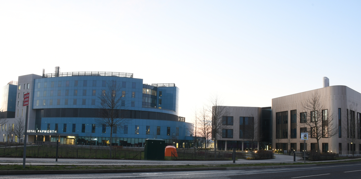 Two buildings, one blue and one bronze.